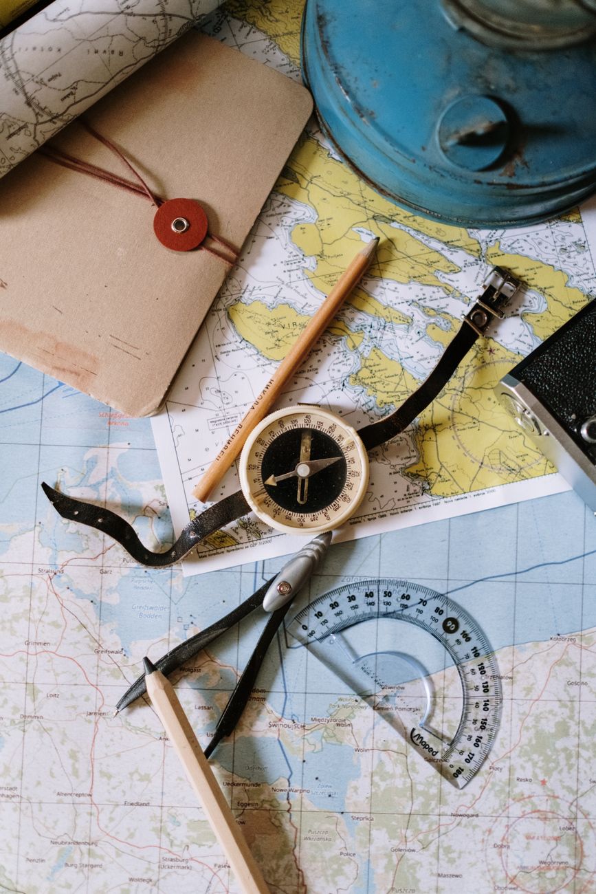 Close-up of a surveying compass dial with the needle pointing north